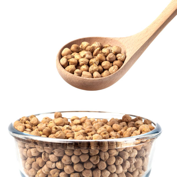 istock Chickpeas on glass bowl with wooden spoon on white background 1130990943