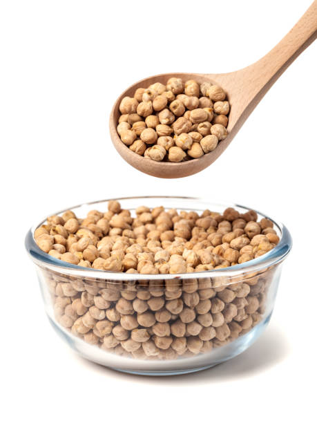 istock Chickpeas on glass bowl with wooden spoon on white background 1130990951