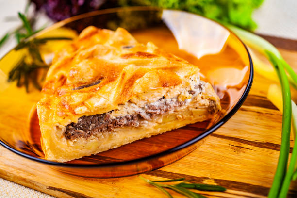 istock Meat pie with potato and onion in glass bowl 1130991584