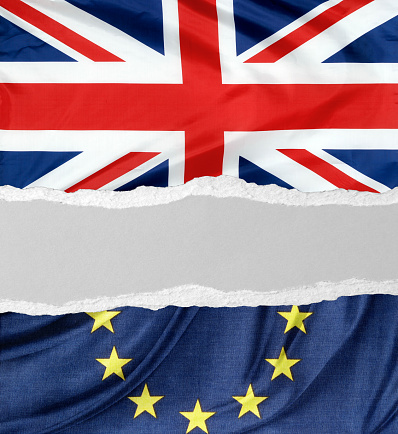 British and European Union flags torn apart. Brexit idea