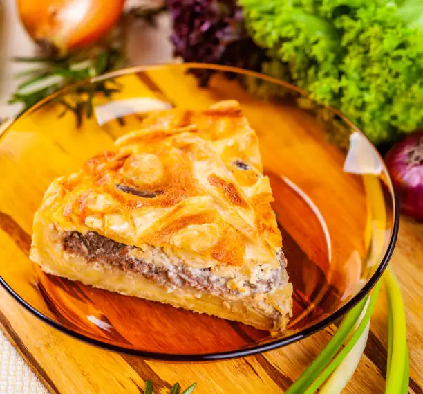 Photo of Meat pie with potato and onion in glass bowl