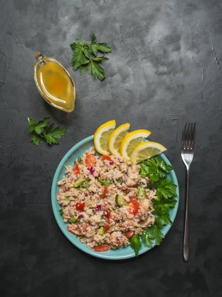 istock Tuna Rice Salad in a plate on black table. 1130993617