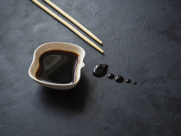istock Chopsticks and soy sauce on black background. 1130993627