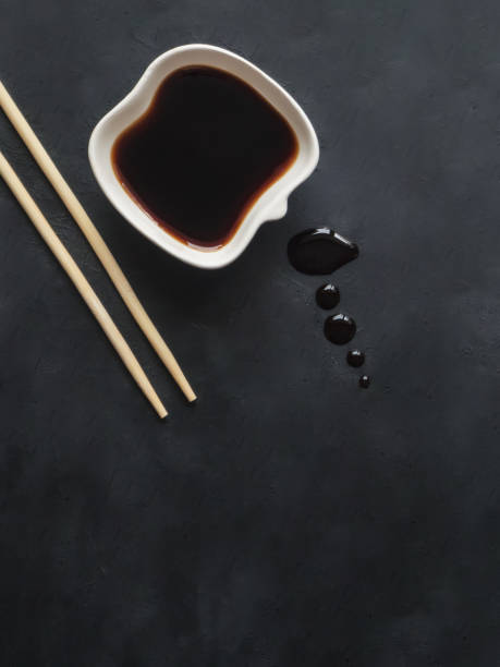 istock Chopsticks and soy sauce on black background. 1130993629