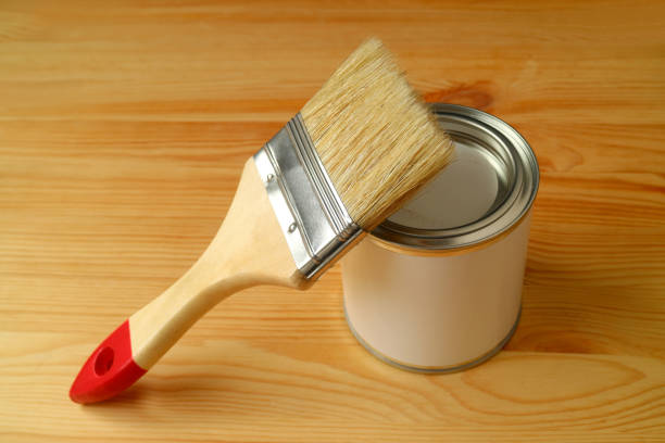 istock Paintbrush on a Paint can isolated on wooden background 1130993795