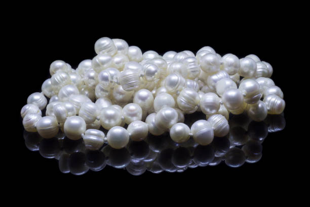 istock Natural white pearl beads on a black background 1130994483