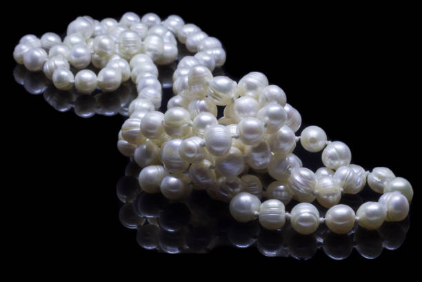 istock Natural white pearl beads on a black background 1130994608