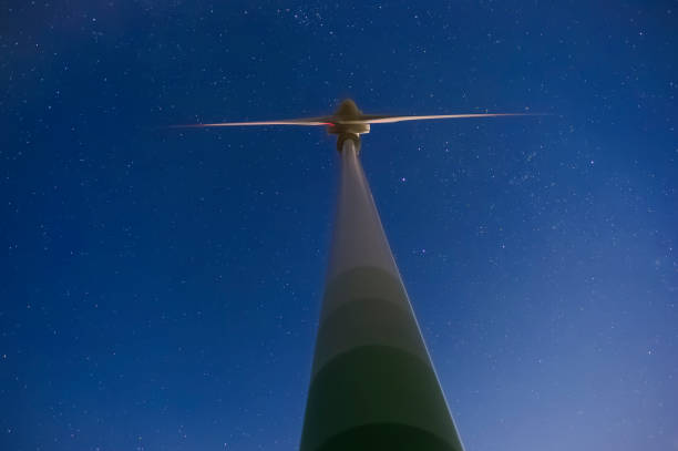 istock wind turbine with night sky star background 1130996632