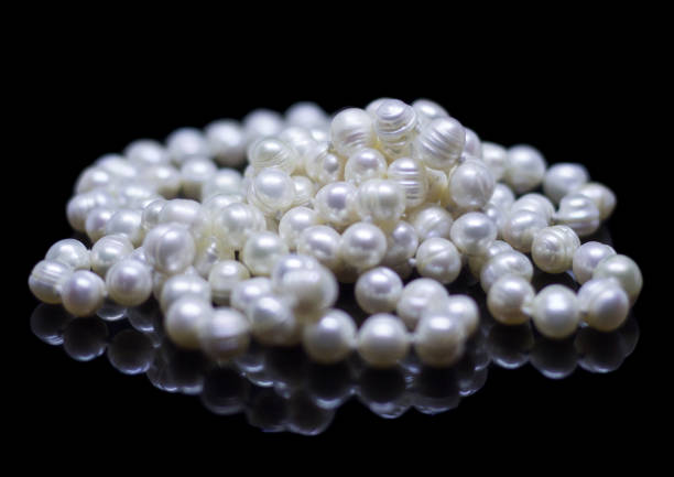istock Natural white pearl beads on a black background 1130996658