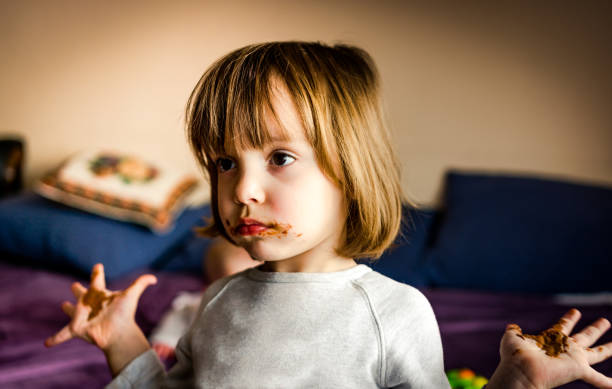 istock Cute little girl with chocolate mustache and beard 1130999363