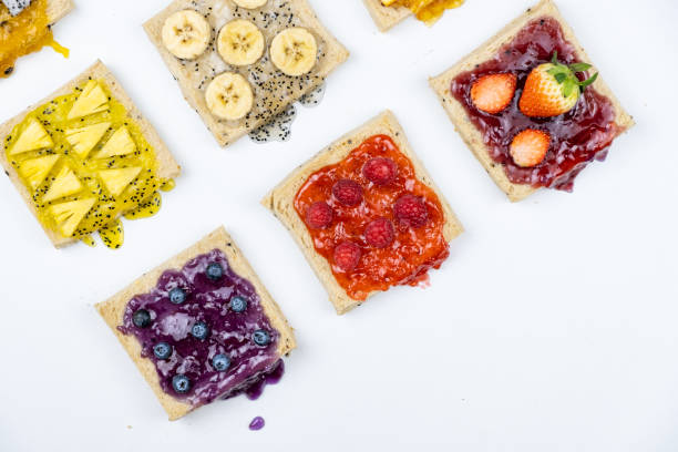 istock Delicious colourful minimal mix fruits jam on sliced bread. Set on white background. 1131003089