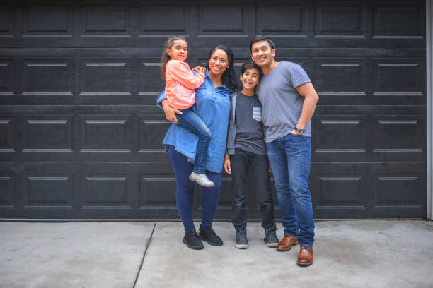 istock Family smiling together against wall 1131003659