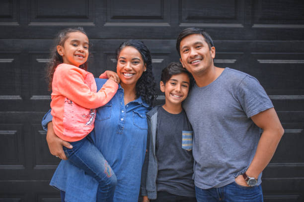 istock Family smiling together against wall 1131003660