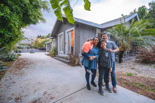 portrait of happy family against house - multi ethnic group family child standing imagens e fotografias de stock