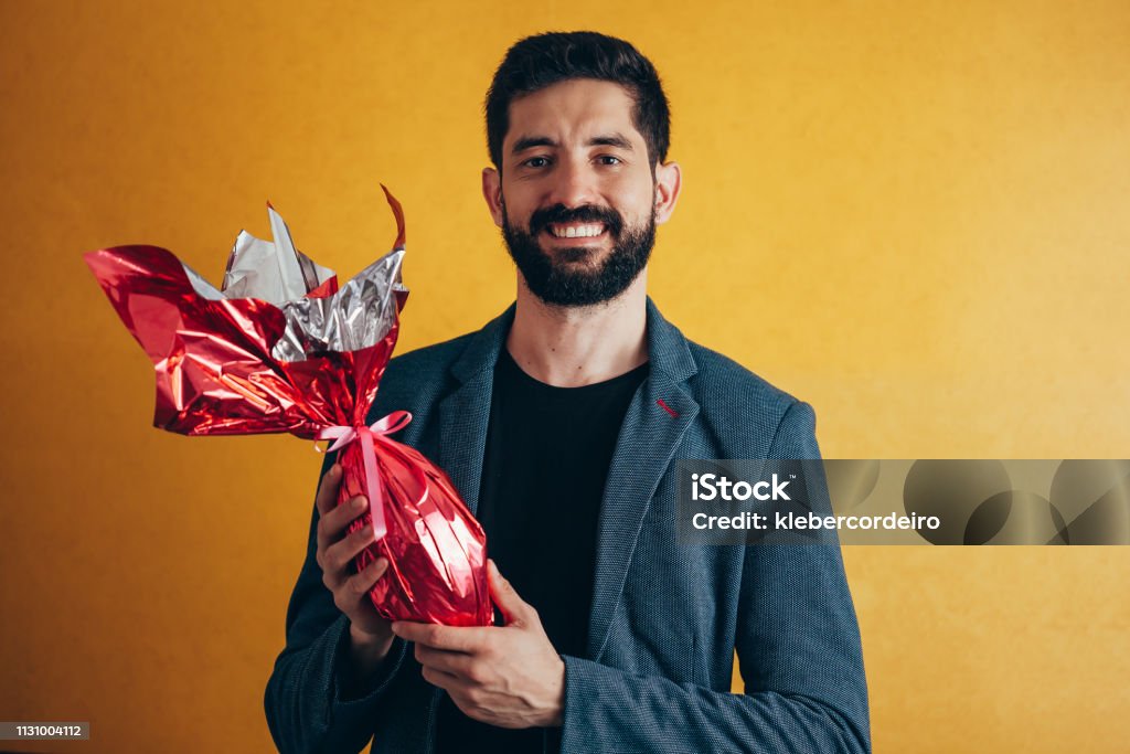 Happy Easter. Happy man holding chocolate easter egg Easter Stock Photo