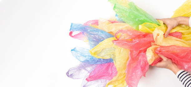 istock Woman hands holding many plastic bags over white background. No plastic, environmental, pollution concept 1131005348
