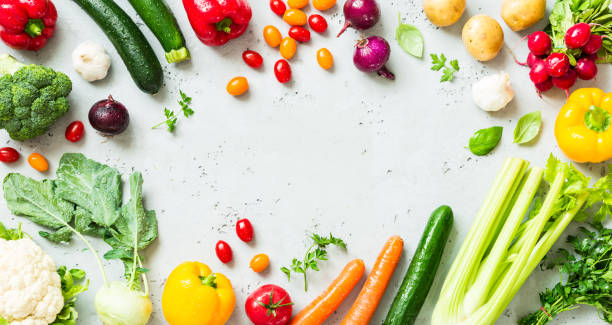 Kitchen - fresh colorful organic vegetables on worktop Kitchen - fresh colorful organic vegetables captured from above (top view, flat lay). Grey stone worktop as background. Layout with free text (copy) space. food flat lay stock pictures, royalty-free photos & images