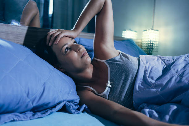 Sleep disorder, insomnia. Young blonde woman lying on the bed awake Sleep disorder, insomnia. Young blonde woman lying on the bed awake horror waking up bed women stock pictures, royalty-free photos & images