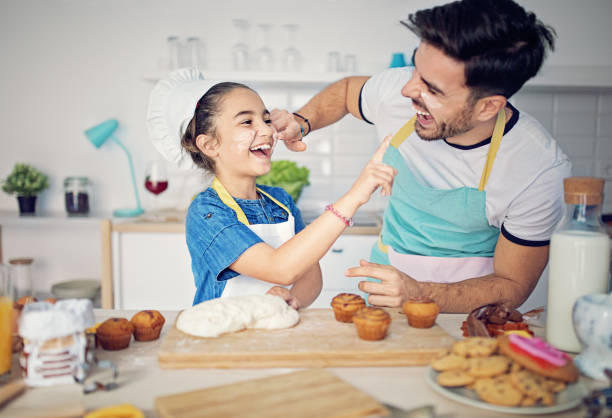 istock Father and daughter are cooking together in the kitchen 1131005464