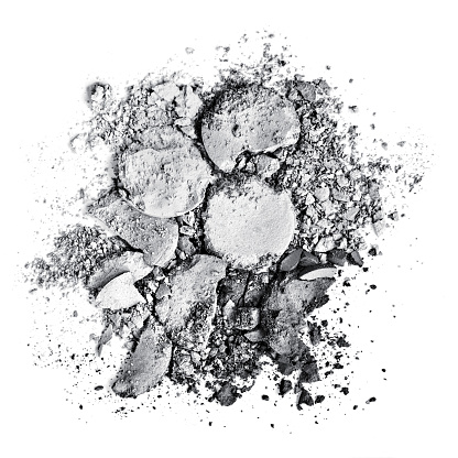 Crushed silver and gray eyeshadow on a white background.