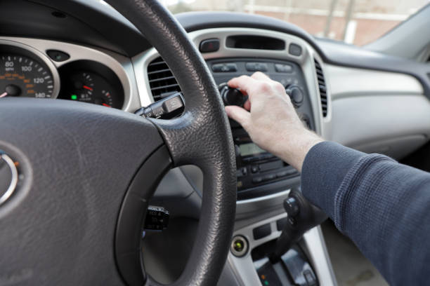 istock Hand on car climate controls with view of steering and dashboard 1131008999