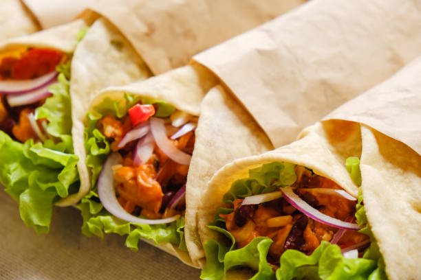 istock Mexican burrito with chicken, pepper and beans close up 1131009280