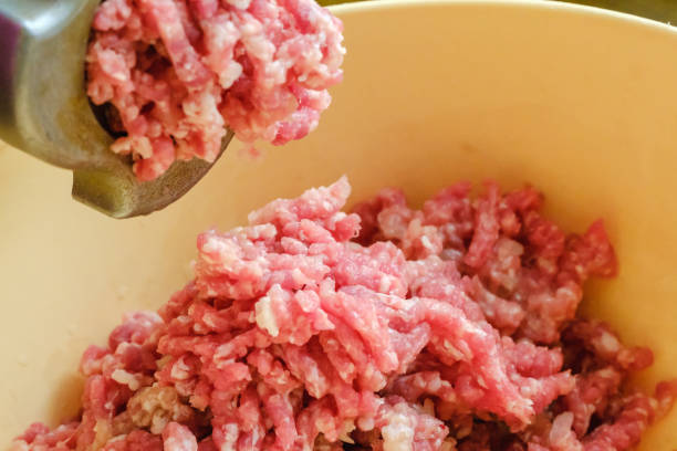 istock Close up meat grinder or mincing-machine with mincemeat in. Showing the forcemeat process. 1131009283