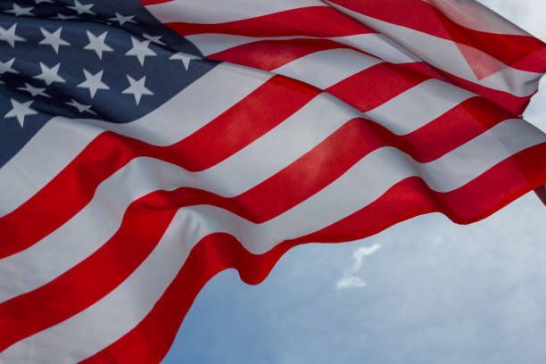 istock Star-stripped American flag against the blue sky. 1131010317
