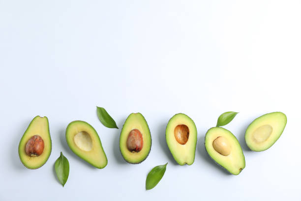 istock Flat lay composition with ripe avocados on white background, space for text 1131013571