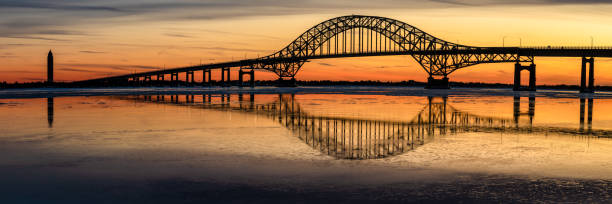 istock Panoramic image of a bridge with an arch and its reflections in the water. 1131013819