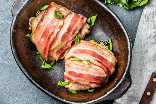 Chicken wrapped in bacon. Top view Chicken wrapped in bacon. Top view. bacon wrapped stock pictures, royalty-free photos & images