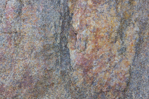 istock Granite texture close up. Granite rocks with porous surface. Background from solid stone. Pattern with natural material 1131019261