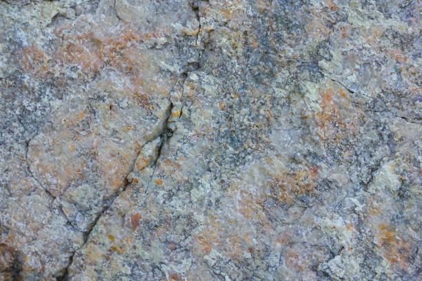istock Granite texture close up. Granite rocks with porous surface. Background from solid stone. Pattern with natural material 1131019319