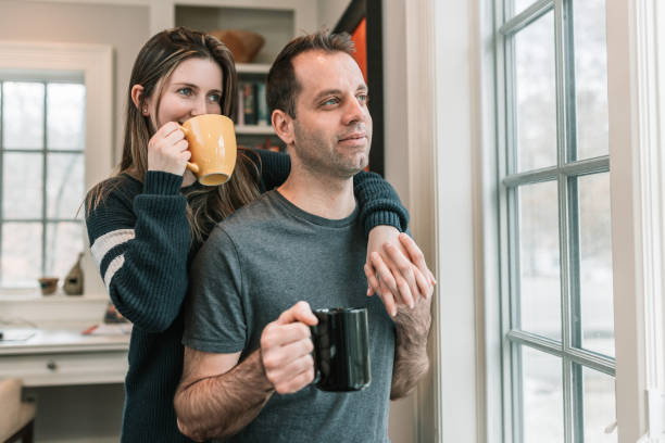 istock Couple having coffee in front of window 1131022420