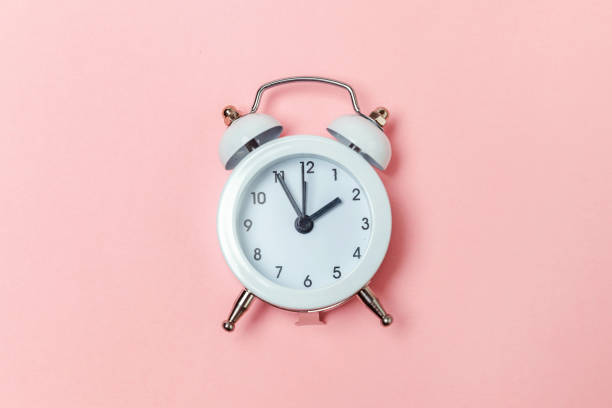 istock Vintage alarm clock Isolated on pink pastel background 1131026444