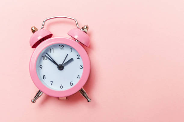 istock Vintage alarm clock Isolated on pink pastel background 1131026654