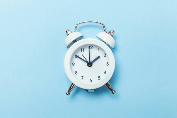 istock Vintage alarm clock Isolated on blue pastel background 1131026685