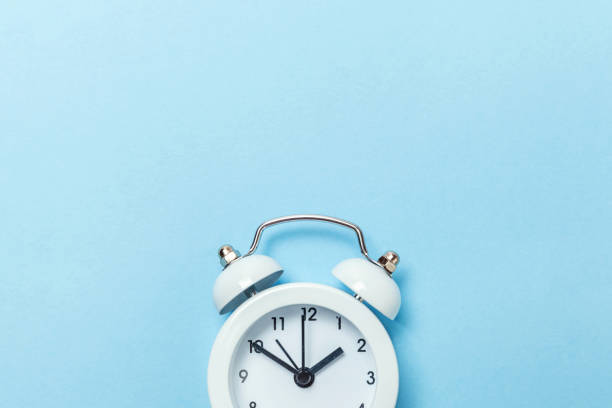 istock Vintage alarm clock Isolated on blue pastel background 1131026689