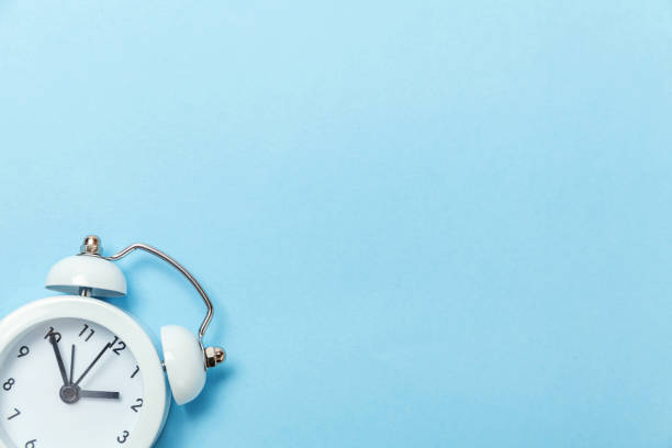 istock Vintage alarm clock Isolated on blue pastel background 1131026696