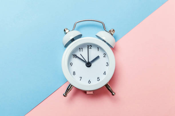 istock Vintage alarm clock Isolated on blue and pink pastel background 1131027207