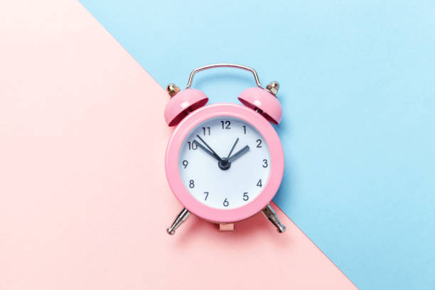 istock Vintage alarm clock Isolated on blue and pink pastel background 1131027217