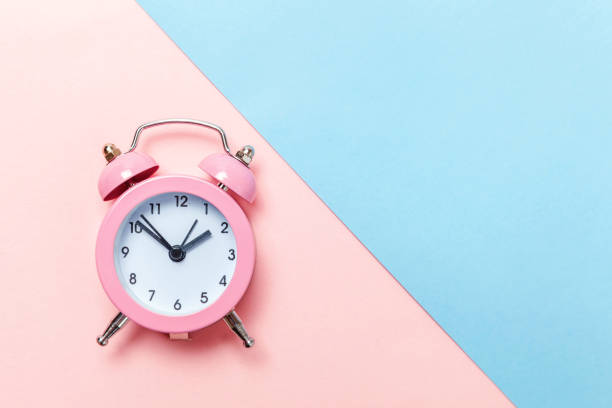 istock Vintage alarm clock Isolated on blue and pink pastel background 1131027222