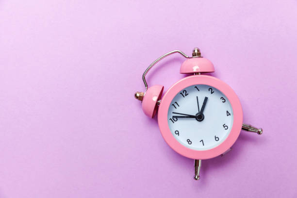 istock Vintage alarm clock Isolated on purple violet pastel background 1131027253