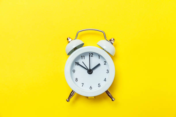 istock Vintage alarm clock Isolated on yellow background 1131027366