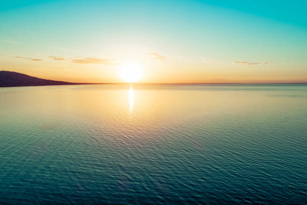 istock Sunset over water - aerial view with copy space 1131027499