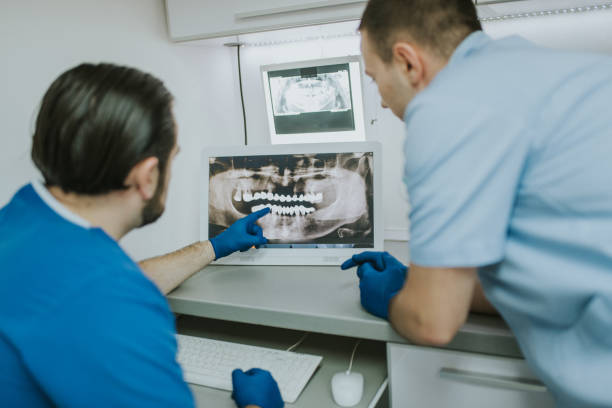 Dentist analyzing x-ray scan stock photo