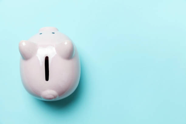 istock Pink piggy bank isolated on blue background 1131028680