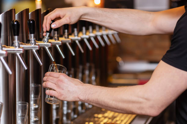 istock innkeeper draws a beer at a beer pump 1131031493