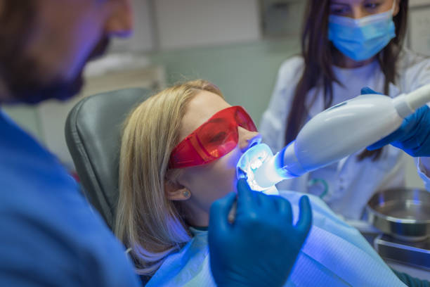 Woman getting laser teeth whitening stock photo