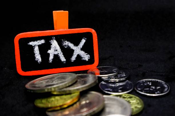 istock The word “TAX” written using chalk on a small board with black background and scattered coins 1131032854